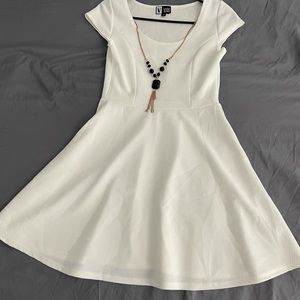 White dress w/ black necklace